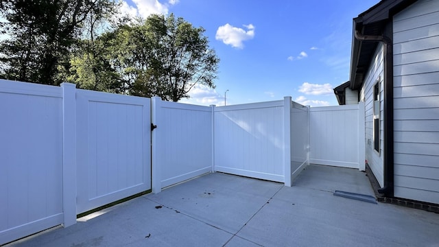 view of patio featuring a gate and fence