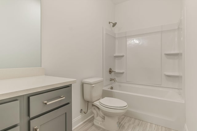 full bath featuring baseboards, shower / tub combination, vanity, and toilet