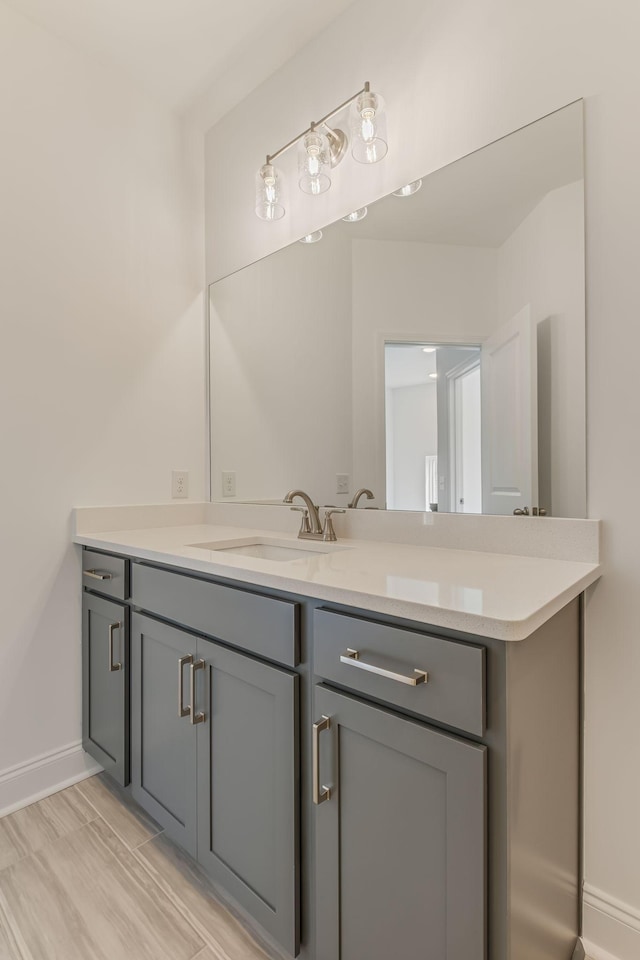 bathroom featuring baseboards and vanity