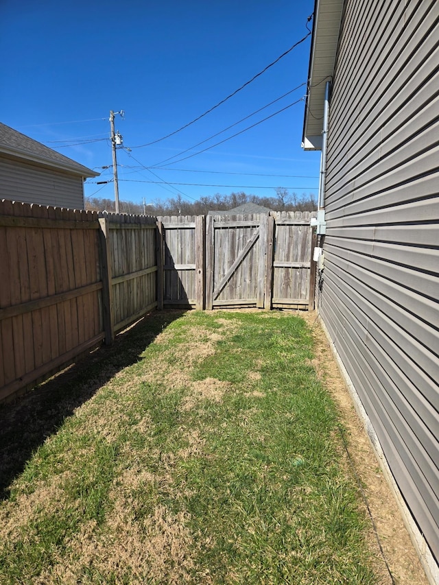 view of yard featuring fence and a gate