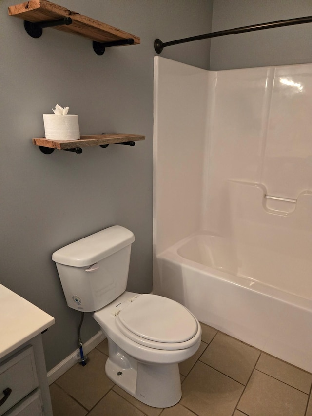 full bathroom with shower / bath combination, baseboards, toilet, tile patterned floors, and vanity