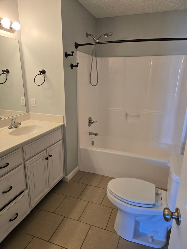 bathroom featuring shower / bath combination, toilet, tile patterned flooring, a textured ceiling, and vanity