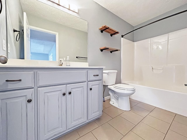 bathroom with toilet, a textured ceiling, tile patterned flooring, bathtub / shower combination, and vanity