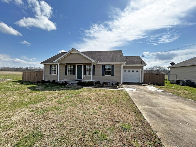 view of front facade featuring driveway, an attached garage, a front yard, and fence