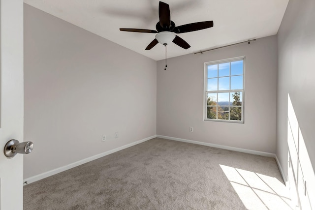 unfurnished room with carpet, ceiling fan, and baseboards