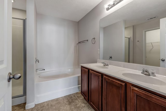 bathroom featuring a sink, visible vents, and a shower stall