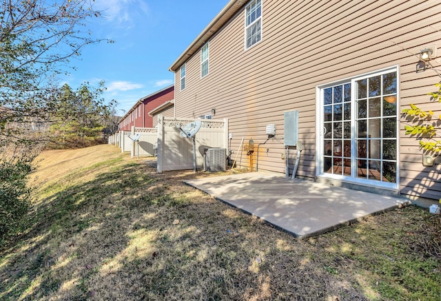 back of property featuring central air condition unit, a patio area, a yard, and fence