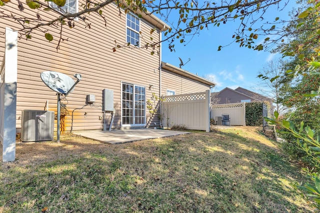 back of house featuring a patio area, a lawn, fence, and cooling unit