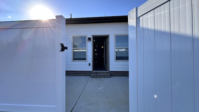 view of exterior entry featuring a patio area