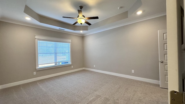 unfurnished room featuring light carpet, a raised ceiling, visible vents, and baseboards