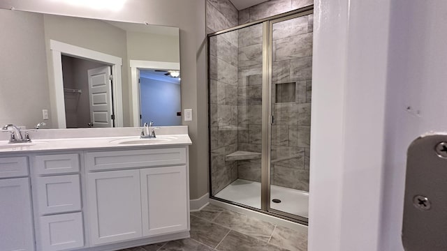 full bath featuring double vanity, a shower stall, and a sink