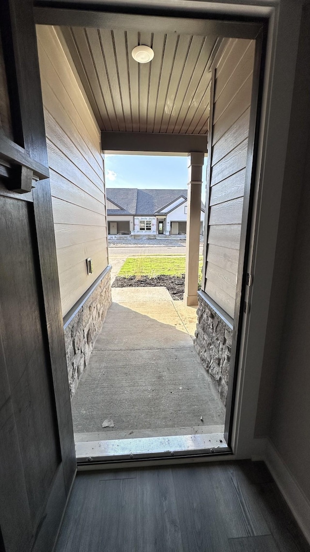 doorway featuring wood finished floors and wood ceiling