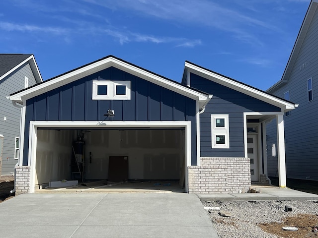 view of front of home featuring concrete driveway, brick siding, board and batten siding, and an attached garage