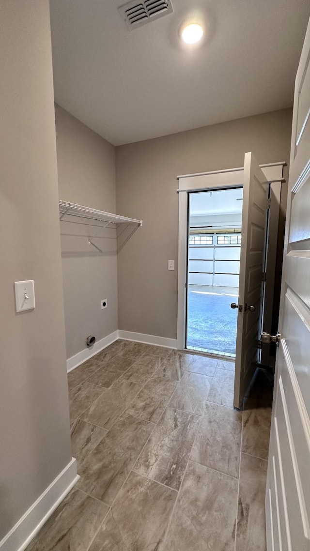 washroom with laundry area, hookup for an electric dryer, visible vents, and baseboards