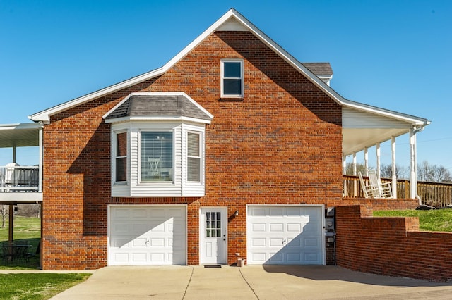 view of home's exterior with concrete driveway, brick siding, and an attached garage