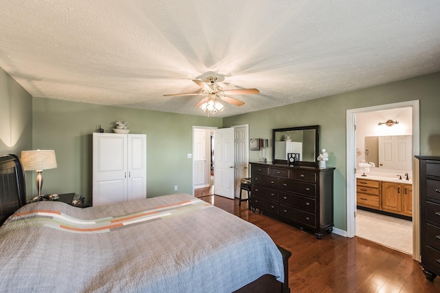 bedroom with a textured ceiling, ceiling fan, wood finished floors, and connected bathroom