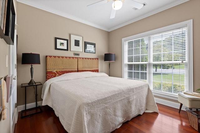 bedroom with dark wood-style floors, crown molding, baseboards, and ceiling fan