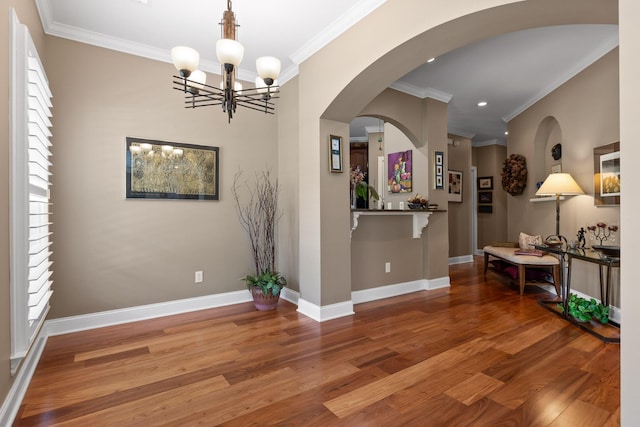 interior space with crown molding, recessed lighting, wood finished floors, a chandelier, and baseboards