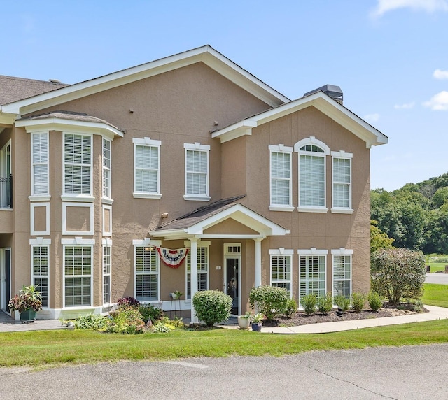 view of front of property with a front lawn and stucco siding