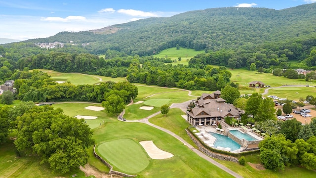 birds eye view of property featuring a forest view, a mountain view, and golf course view