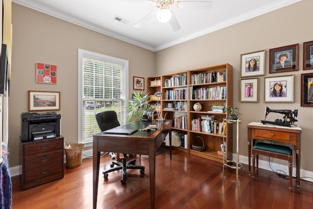 home office with wood finished floors, a ceiling fan, visible vents, baseboards, and ornamental molding