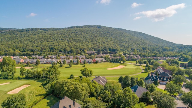 birds eye view of property with view of golf course, a forest view, a residential view, and a mountain view