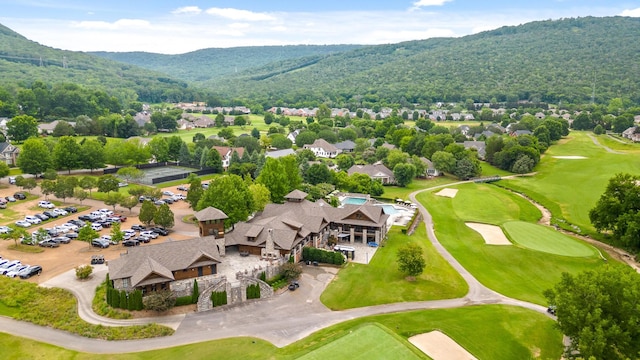 drone / aerial view with a mountain view and golf course view