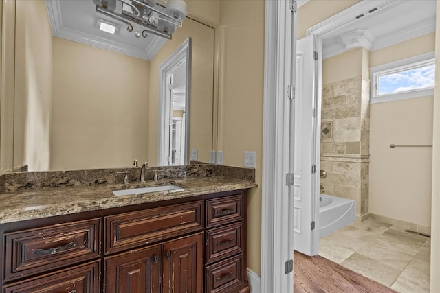 bathroom with baseboards, shower / washtub combination, vanity, and crown molding