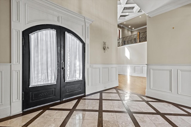 entrance foyer featuring french doors, recessed lighting, a decorative wall, ornamental molding, and baseboards