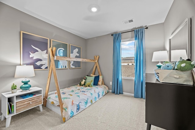 carpeted bedroom featuring visible vents and baseboards