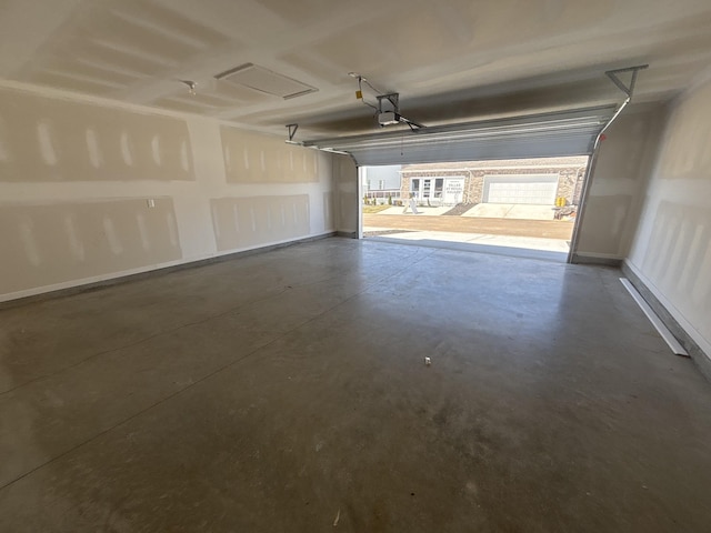 garage with a garage door opener and baseboards