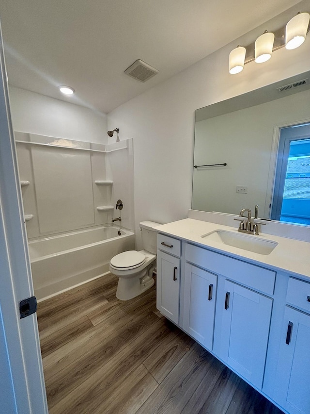 full bath featuring visible vents, toilet, vanity, and wood finished floors