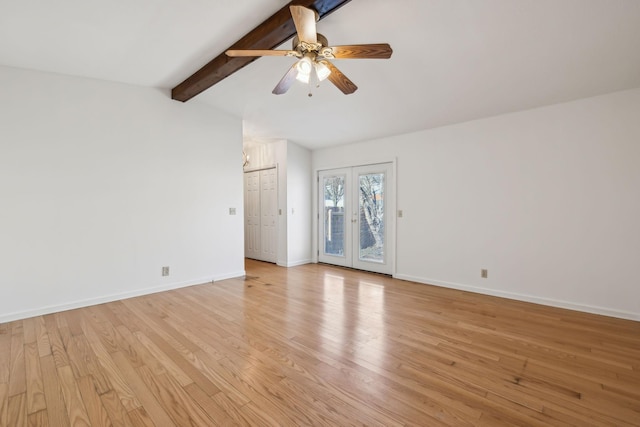 spare room with vaulted ceiling with beams, french doors, light wood-type flooring, and baseboards