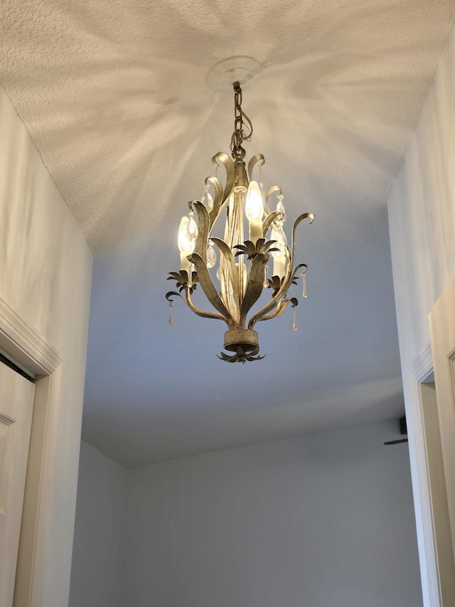 room details with a chandelier and a textured ceiling