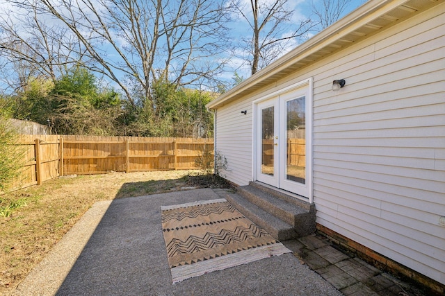 exterior space featuring entry steps, french doors, and fence