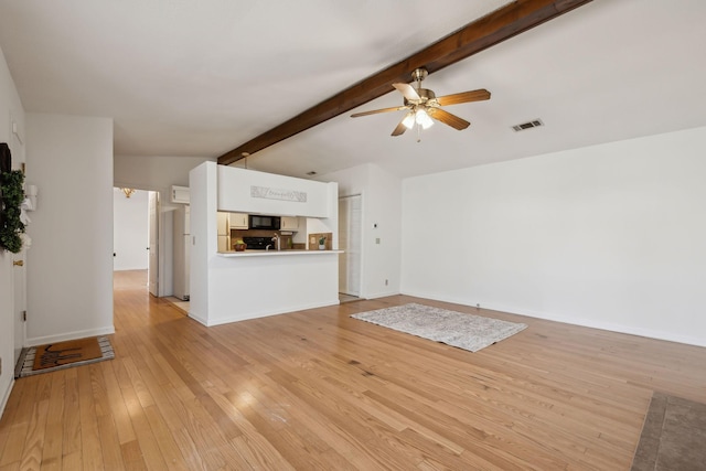 unfurnished living room with lofted ceiling with beams, visible vents, baseboards, a ceiling fan, and light wood finished floors