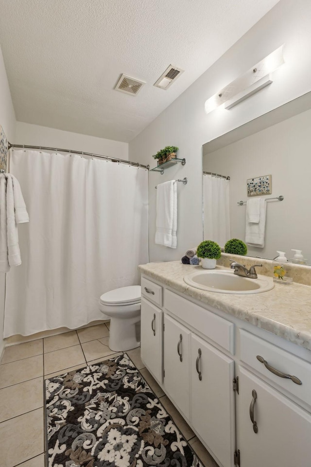 full bath featuring tile patterned flooring, visible vents, a textured ceiling, and toilet