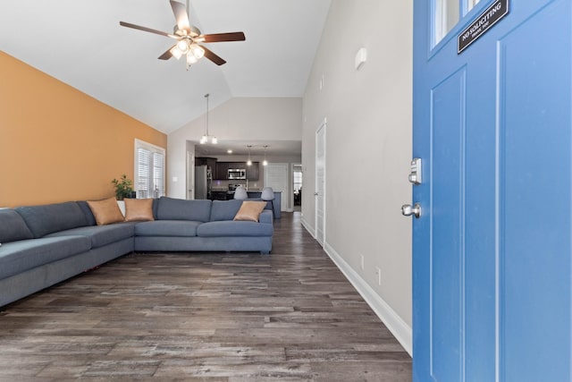 living area featuring dark wood-style floors, high vaulted ceiling, ceiling fan, and baseboards