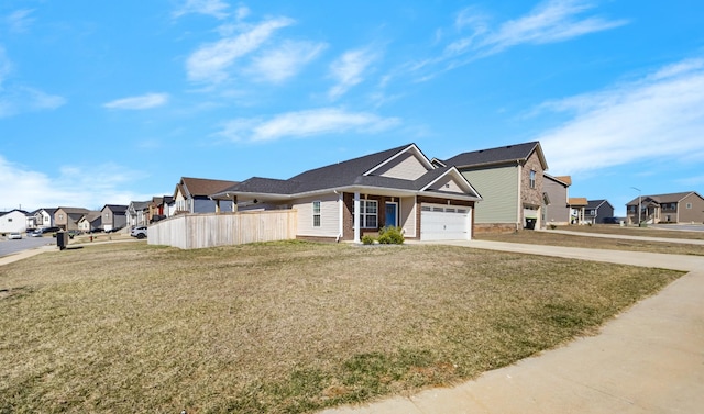 view of front of property with an attached garage, driveway, a residential view, and a front lawn