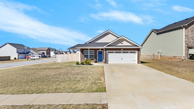 view of front of house featuring a garage, driveway, a front yard, and brick siding