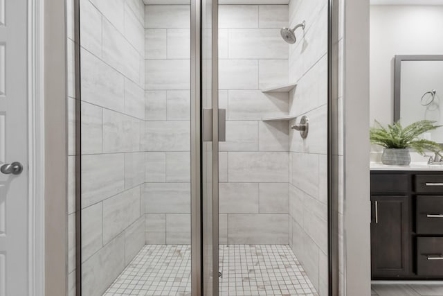 bathroom with a stall shower and vanity