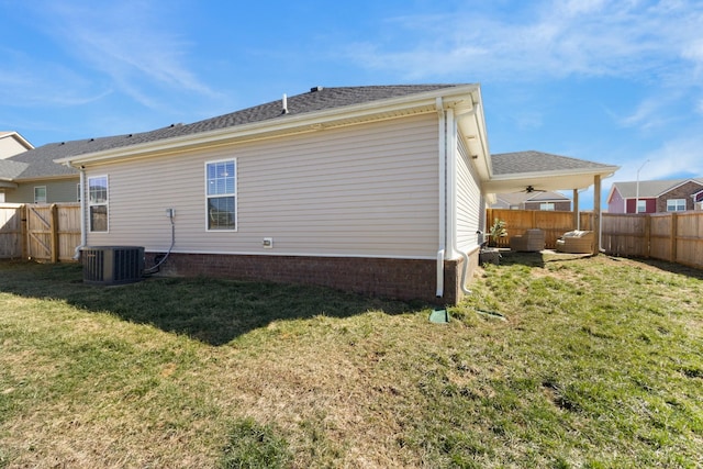 back of house with a yard, cooling unit, and a fenced backyard