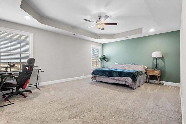 carpeted bedroom with baseboards, a raised ceiling, a ceiling fan, and recessed lighting