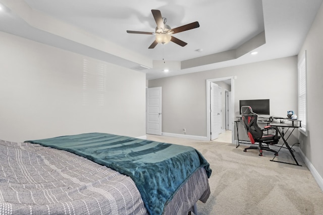 bedroom featuring recessed lighting, a raised ceiling, light carpet, ceiling fan, and baseboards