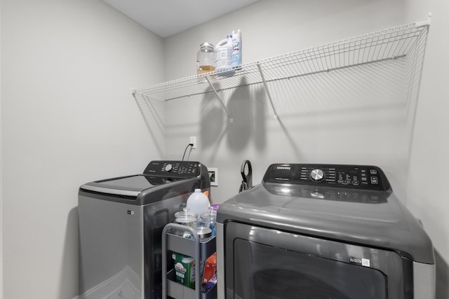 clothes washing area with washer and dryer and laundry area