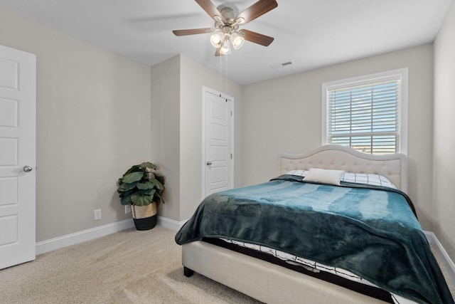 carpeted bedroom with a ceiling fan, visible vents, and baseboards