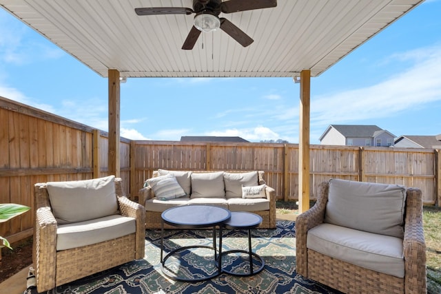 view of patio with ceiling fan, a fenced backyard, and an outdoor living space