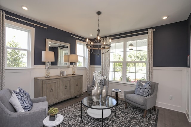 sitting room featuring a wainscoted wall, a notable chandelier, dark wood finished floors, and recessed lighting