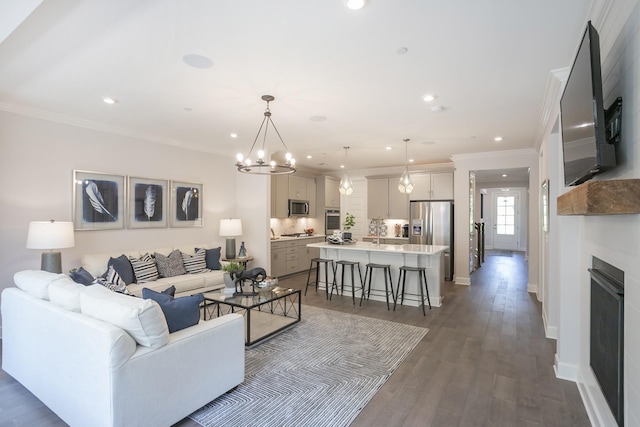 living area with ornamental molding, recessed lighting, dark wood finished floors, and baseboards