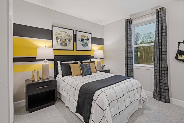 carpeted bedroom featuring baseboards